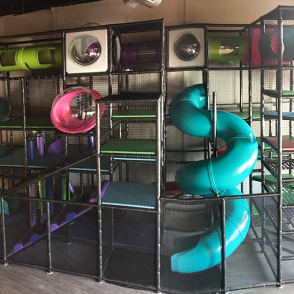 Go Play Systems Custom Design: teal slides, pink spheres, gecko green crawl tubes, white junction boxes, tower climbs